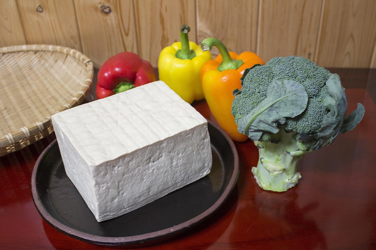 Extra firm tofu, surrounded by broccoli and bell peppers.